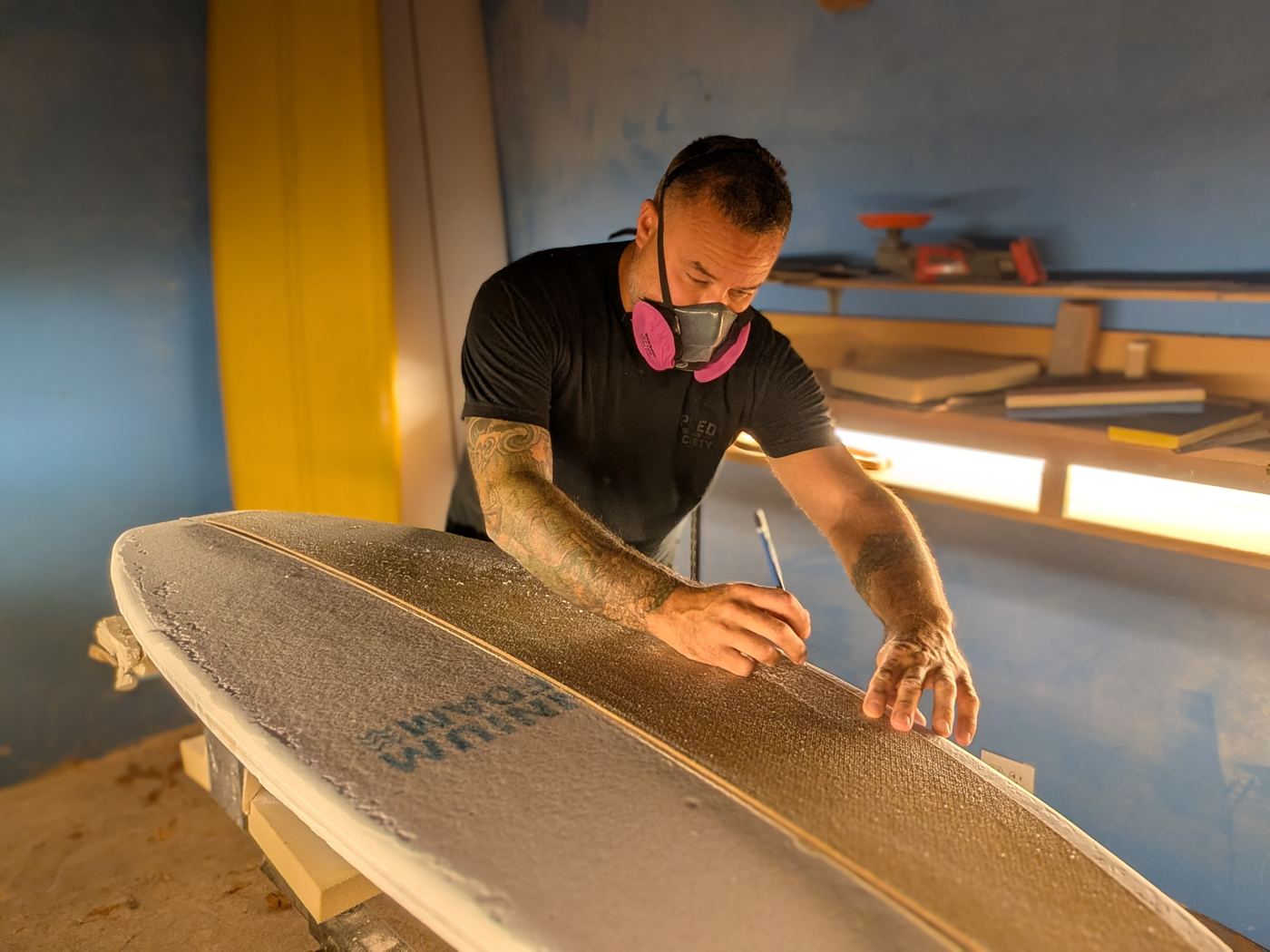 Brian working on a board in the shaping bay