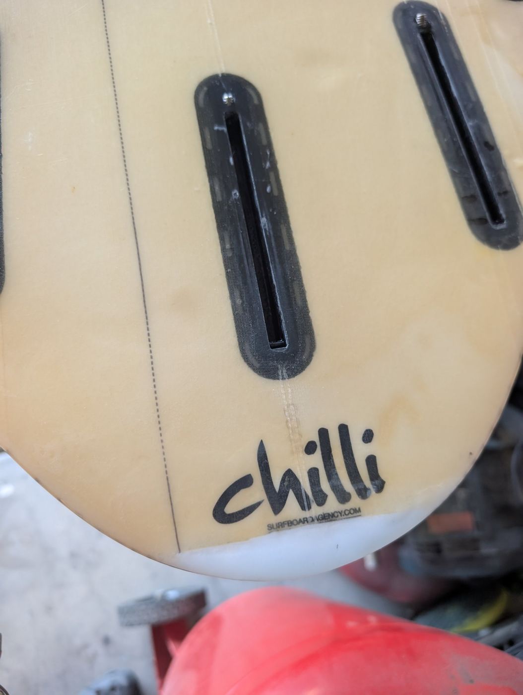 Tail of a Chilli shortboard showing the fin boxes and a repaired tail tip