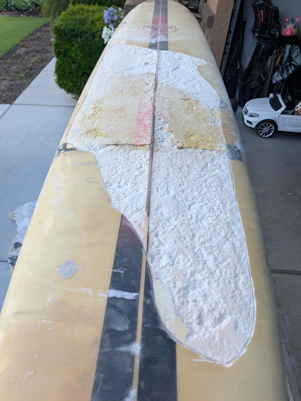 Old glass and failed patches stripped back to bare foam